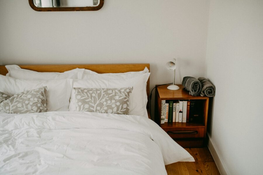 Cozy bedroom neatly made bed soft bedding