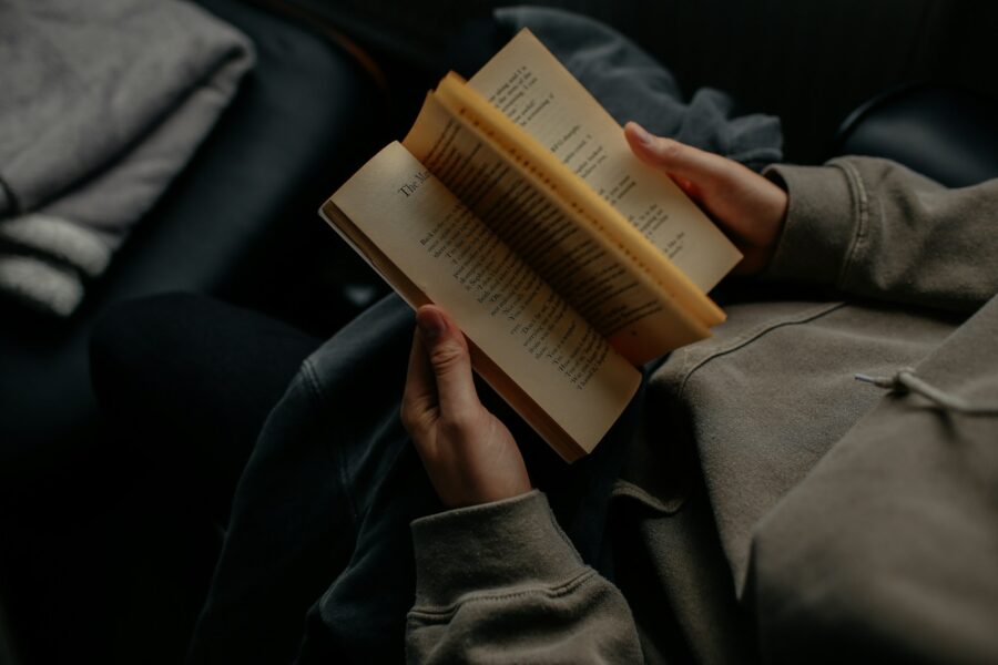 Person reading book bed night