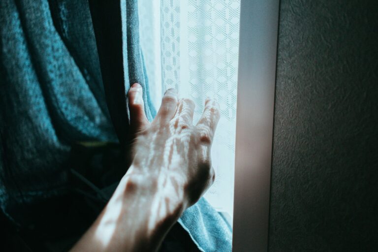 Person stretching window soft morning light