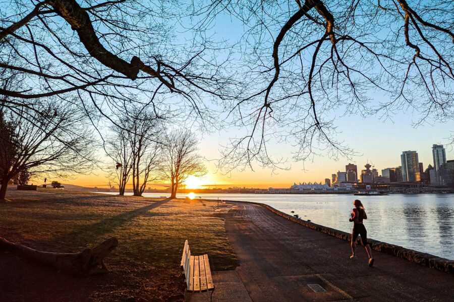 Woman walking outside park path sunrise