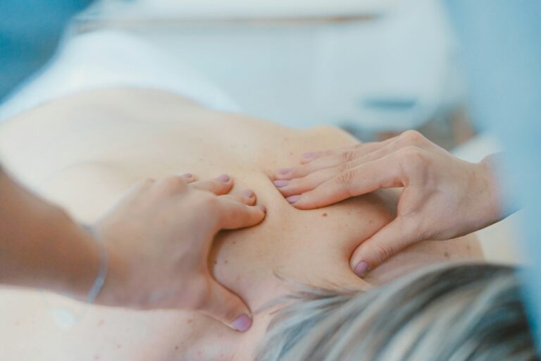 Close hands massaging tense shoulder