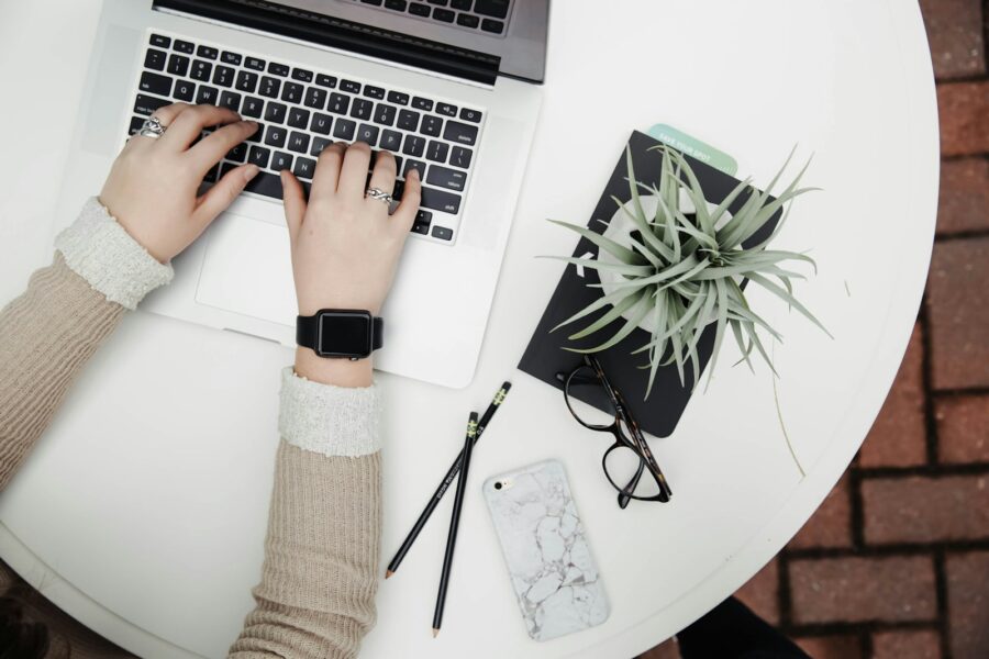 Person working laptop home desk freelancing