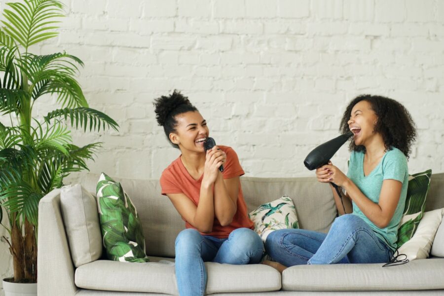 Two friends talking sofa cozy living room