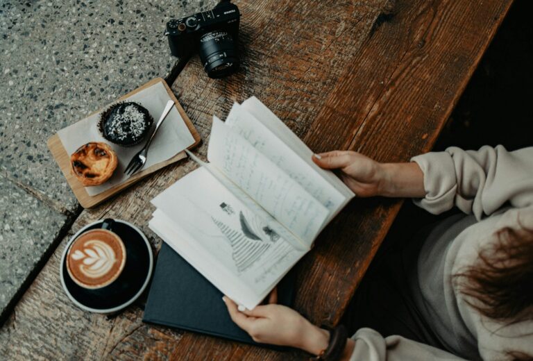 Person journaling cup tea table