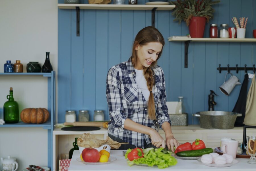 Home cook chopping vegetables cutting board