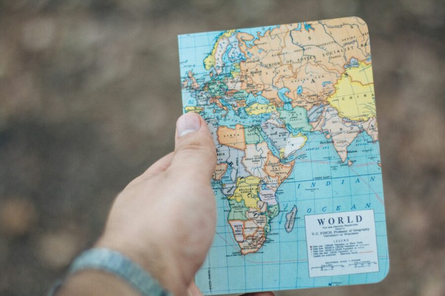 Person planning trip map notebook coffee