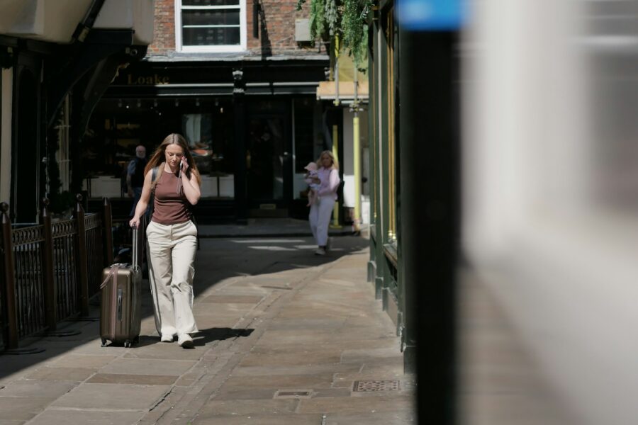 Business traveler walking city street suitcase