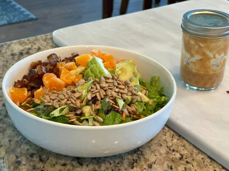 Chopped salad ingredients bowls homemade salad dressing jar