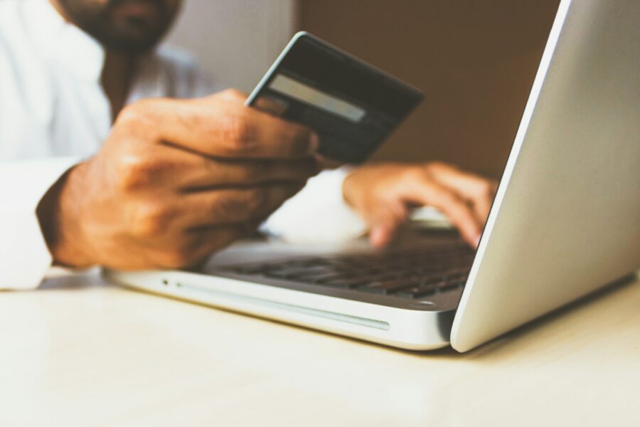 Person using credit card laptop