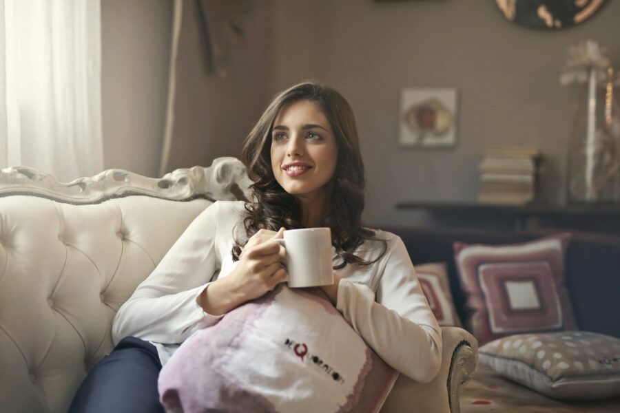 Woman relaxing sofa cup tea