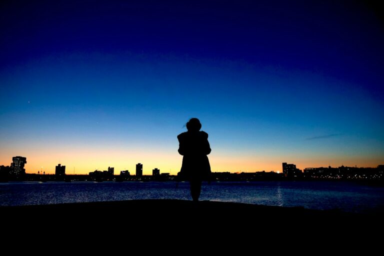 Person walking alone city dusk