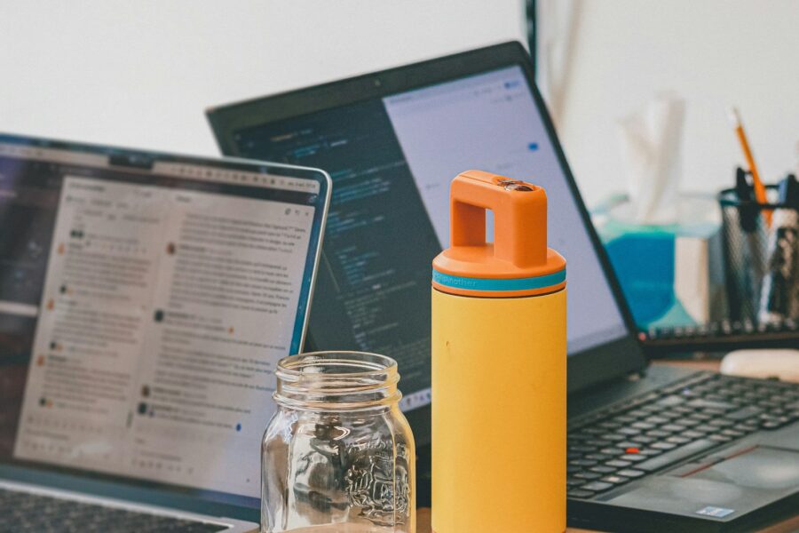 Desk workspace water bottle notebook phone