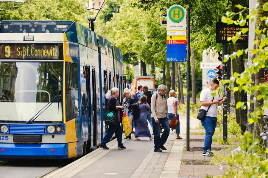 City tram bus stop people street