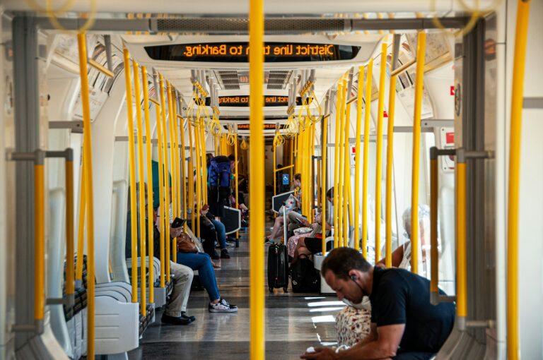 Metro station platform timetable bus interior passengers handrails