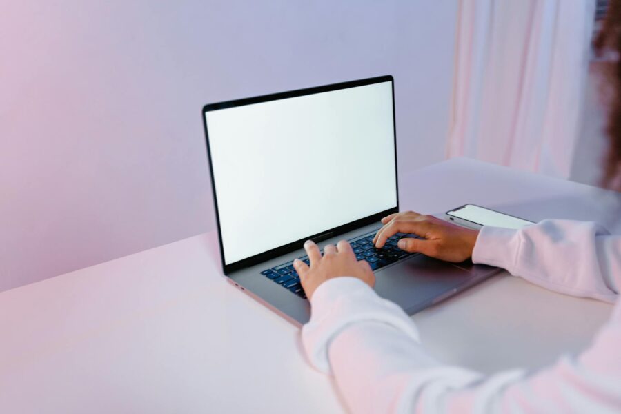 Person using laptop chatbot interface desk