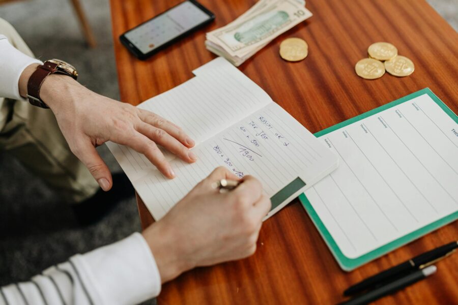 Person writing expenses