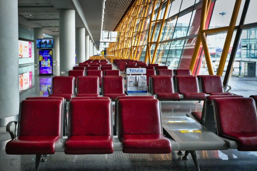 Airport seating area traveler backpack laptop