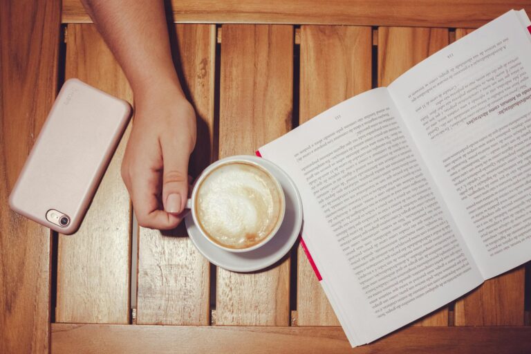 Smartphone table next book cup person enabling not