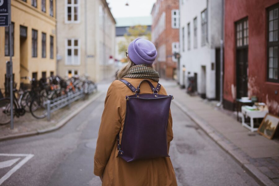 Solo traveler walking city street backpack