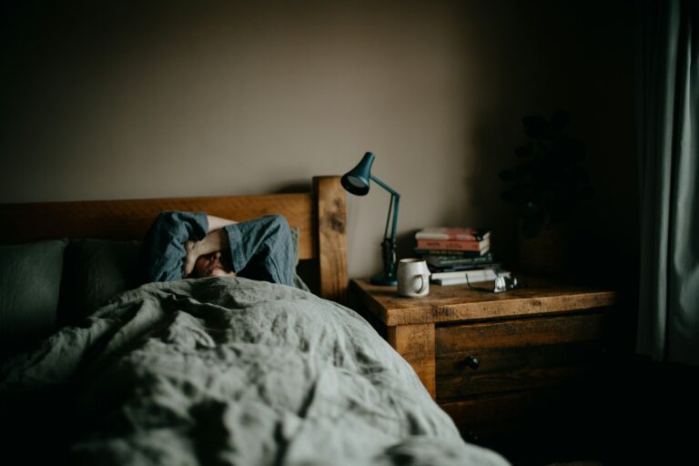 Cozy bedroom lamp soft blanket night person journaling