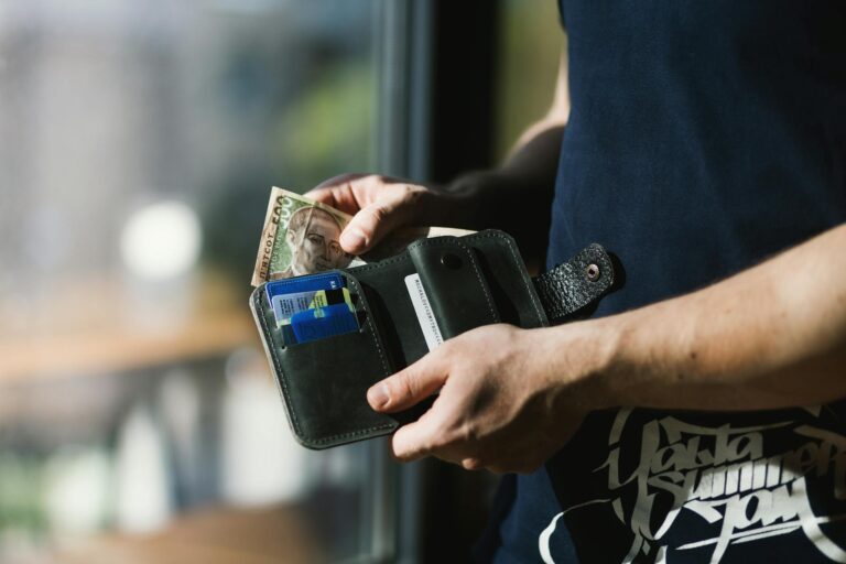 Person holding cash envelope wallet