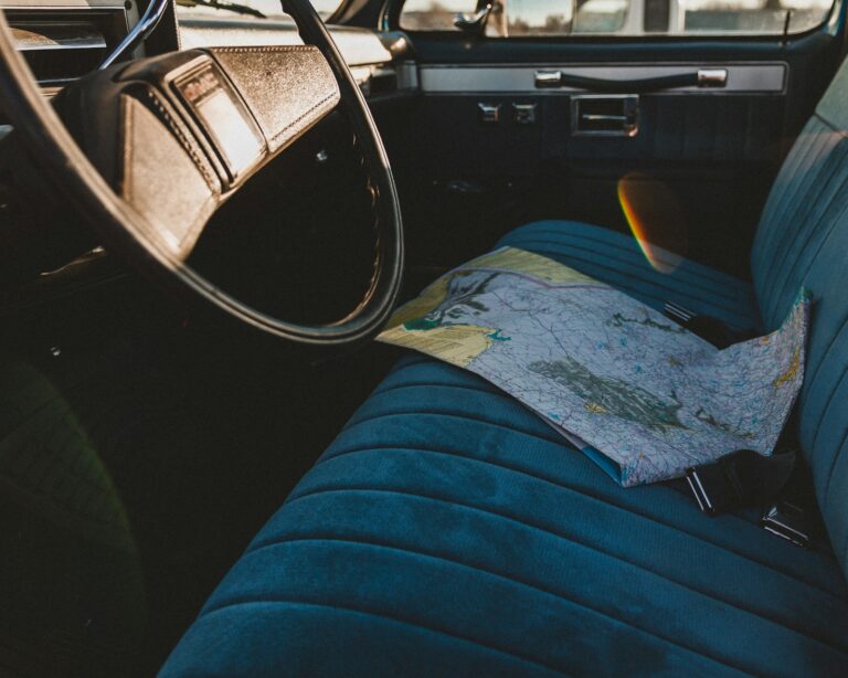 Packed car trunk summer luggage road trip map