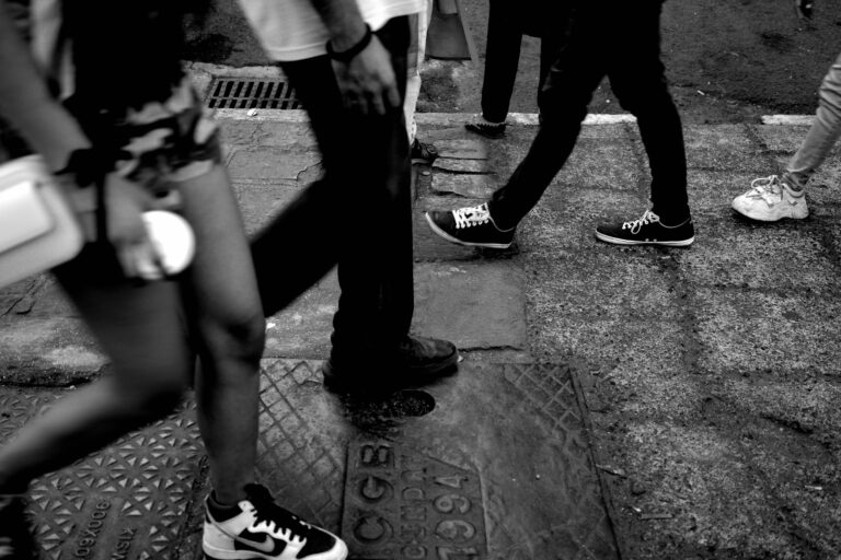 Feet walking sidewalk